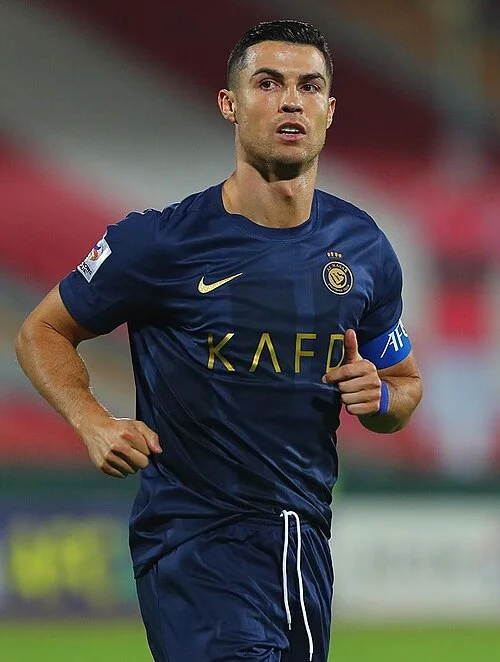 Cristiano Ronaldo in the Al-Nassr kit with the captain's armband — the richest football player in the world in 2026