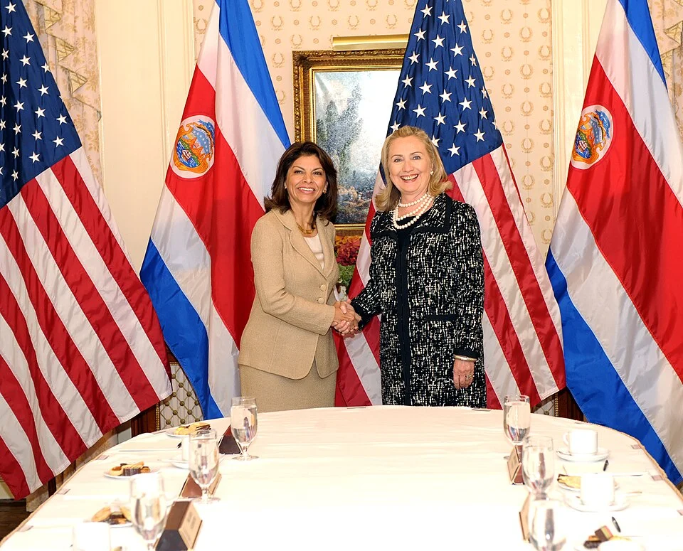 Laura Chinchilla shaking hands with U.S. Secretary of State Hillary Clinton at a diplomatic meeting