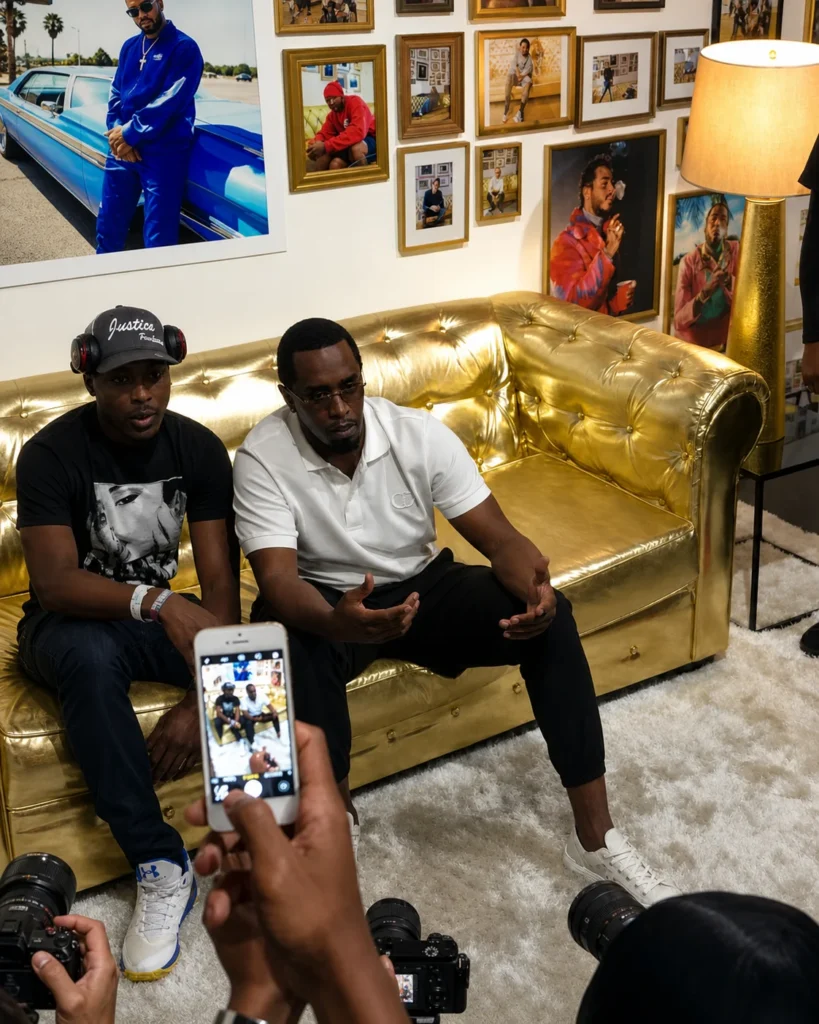 Sean Diddy Combs seated on gold couch during media appearance