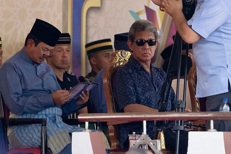 Prince Jefri Bolkiah wearing sunglasses, seated at the 2024 Majlis Ramah Mesra official event in Belait, Brunei, July 2024