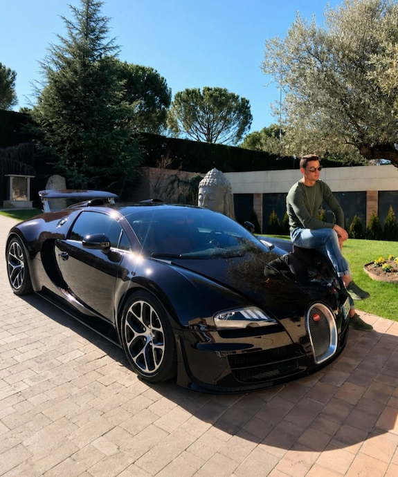Cristiano Ronaldo sitting on his black Bugatti Veyron Grand Sport Vitesse