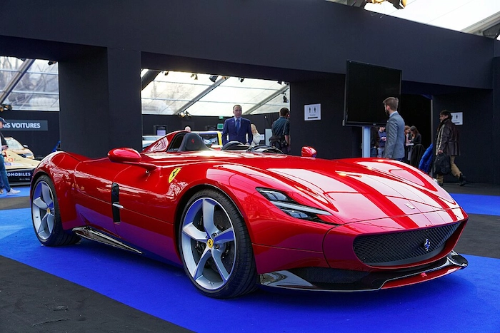 Red Ferrari Monza SP1 single-seater barchetta on display at a motor show