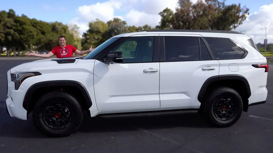 Doug DeMuro standing beside his white 2024 Toyota Sequoia TRD Pro, his current family vehicle