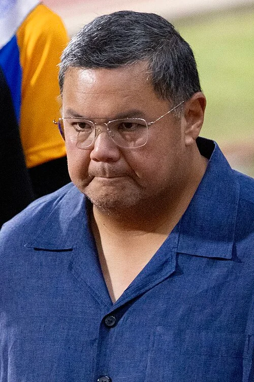 Prince Abdul Hakeem of Brunei, eldest son of Prince Jefri Bolkiah, wearing glasses and a blue shirt at a public event