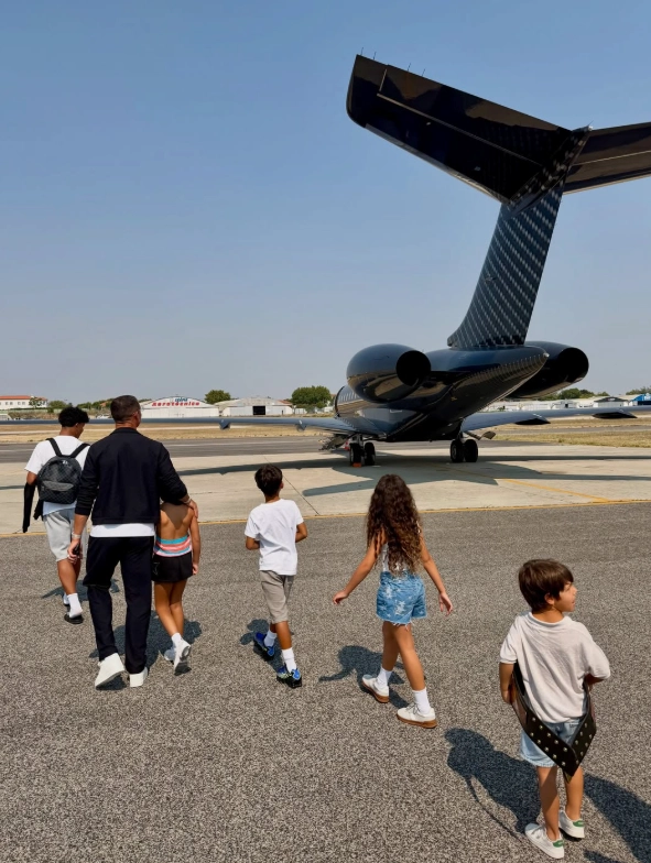 Cristiano Ronaldo and his family walking towards his private Gulfstream jet on the tarmac