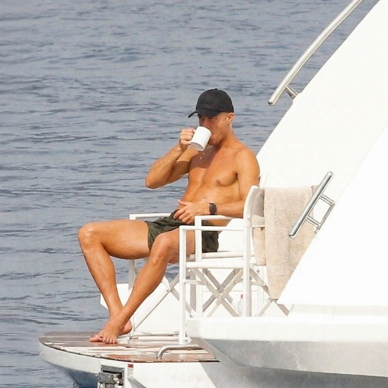 Cristiano Ronaldo relaxing with coffee on the stern platform of his yacht during a Mediterranean summer break