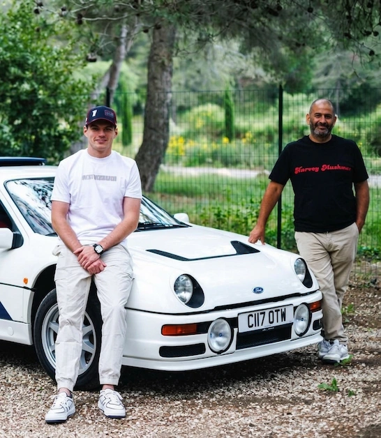 F1 champion Max Verstappen and Top Gear presenter Chris Harris with the iconic Ford RS200 (C117 OTW) in a casual outdoor photoshoot for Ford Performance
