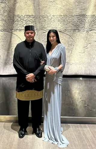 Prince Abdul Hakeem of Brunei standing with his wife at a formal event
