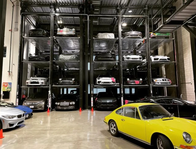 Interior of Matt Farah's Westside Collector Car Storage facility showing multi-level car stacking lifts