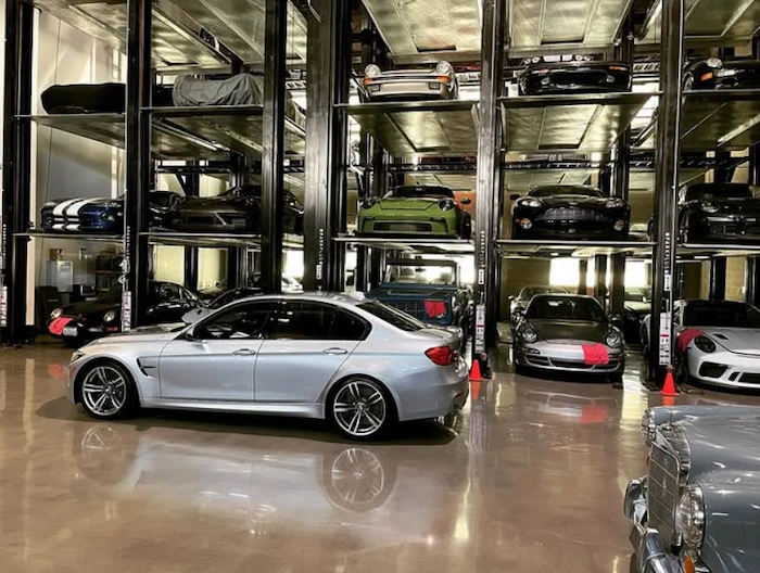 Interior of Westside Collector Car Storage showing customer-owned vehicles on multi-level stacking lifts