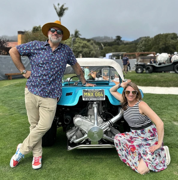 Matt Farah and his wife Hanna posing with a custom car at an automotive event
